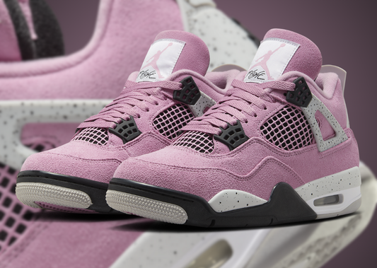 Pink sneakers with black and white accents on a blurred background